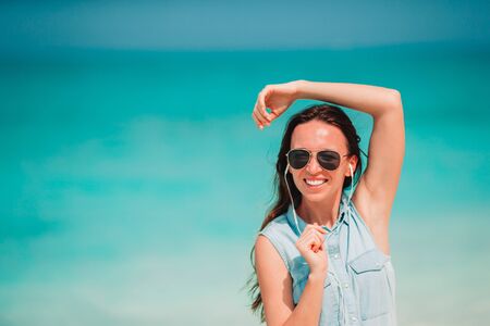 Young fashion woman in green dress on the beach