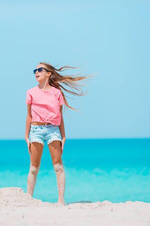 Adorable little girl at tropical beach on vacationの写真素材