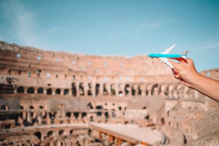 Closeup toy airplane on Colosseum background. Italian european vacation in Rome. Concept of imagination.の写真素材