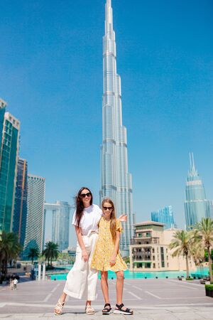 Happy family walking in Dubai with skyscrapers in the background.の写真素材