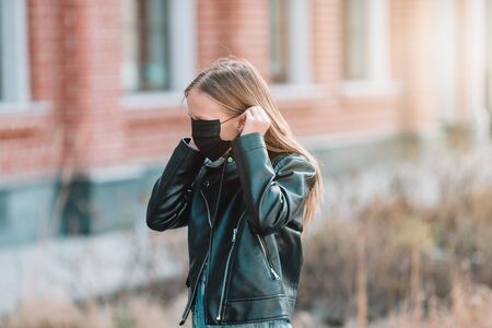 Girl wearing a mask protect against Coronavirus and grippの写真素材