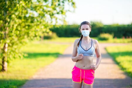 Sportive fit young woman in the park. Healthy caucasian runner girl living a healthy lifestyle.の写真素材