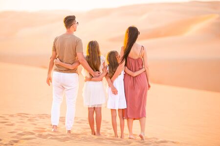 Young family in big sand desertの写真素材
