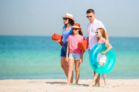 Family of parents and children on the beach having funの写真素材