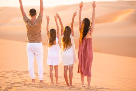 Family in big sand desert on summer vacationの写真素材