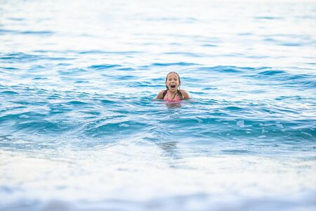 Cute little girl at beach during caribbean vacation