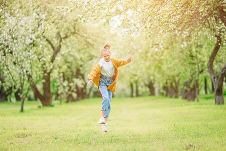 Little smiling girl playing in the parkの写真素材