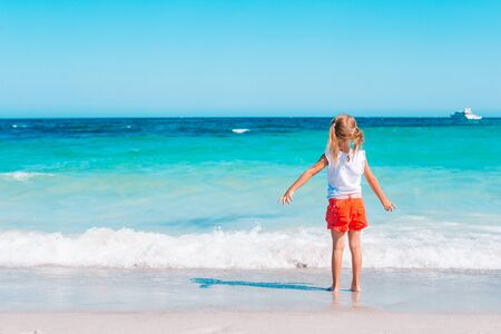Adorable little girl at beach during summer vacationの写真素材