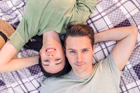 Picnic time. Young couple having fun on picnic in the park.の写真素材