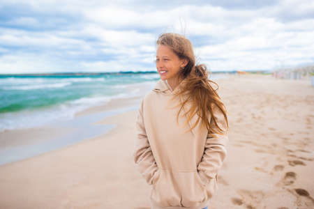 Young girl on the beach in the stormの写真素材