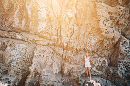 Cheese rocks from quartzite sandstone on Balck Sea in Crimea. Tourist girl in mountains