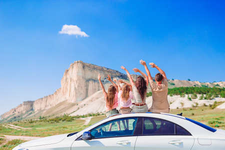 Parents and two little kids on summer car vacationの写真素材