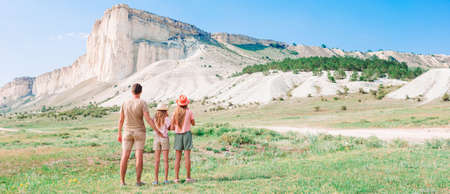 Happy beautiful family on a tropical beach vacationの写真素材