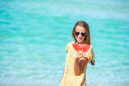Adorable little girl have fun at tropical beach during vacationの写真素材