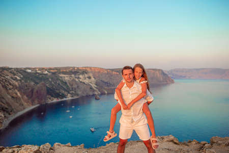 Happy family of two walking in the mountains on the sunsetの写真素材