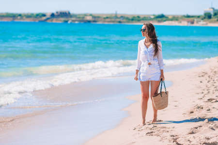 Young woman in white on the beachの写真素材