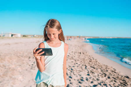 Adorable little girl at beach during summer vacation
