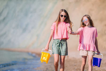 Adorable little girls having fun on the beach