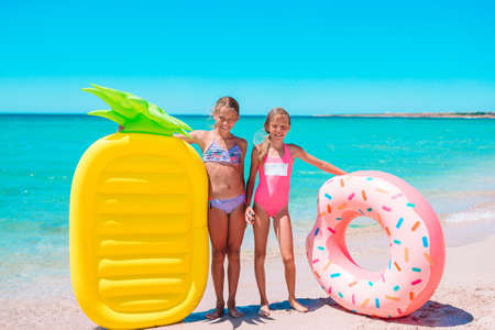 Little girls having fun at tropical beach during summer vacation playing togetherの写真素材