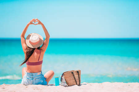 Young woman in hat on the beach vacationの写真素材