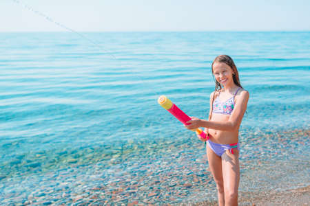 Adorable active little girl at beach during summer vacationの写真素材