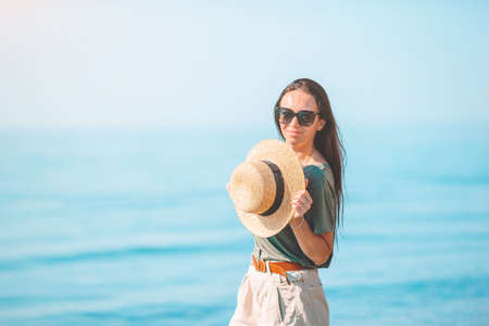 Young woman in white on the beach