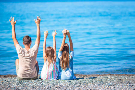 Happy beautiful family on a tropical beach vacationの写真素材