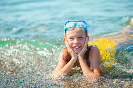 Cute little girl at beach during summer vacationの写真素材