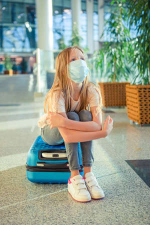 Little kid in medical mask in airport waiting for boardingの写真素材
