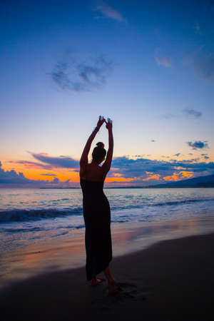 Woman laying on the beach enjoying summer holidays looking at the seaの写真素材