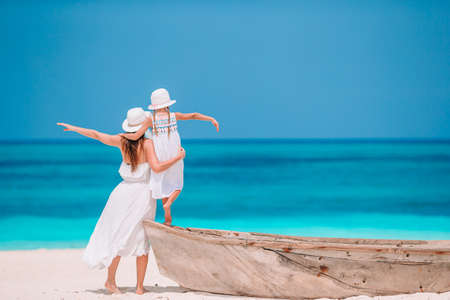 Beautiful mother and daughter at Caribbean beach enjoying summer vacation.の写真素材