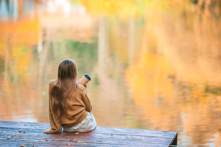 Adorable little girl at beautiful autumn day outdoorsの写真素材