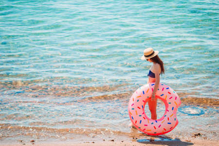 Young woman in white on the beach
