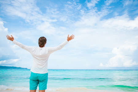 Young man on the white beach on vacationの写真素材