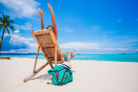 Woman laying on the beach enjoying summer holidays looking at the seaの写真素材