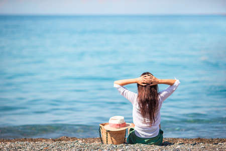 Young woman in hat on the beach vacationの写真素材