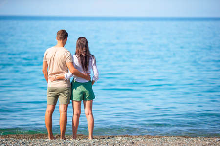 Young couple on white beach during summer vacation.