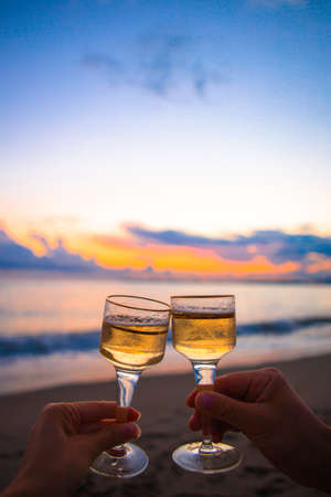 two glasses on the white sandy beachの写真素材
