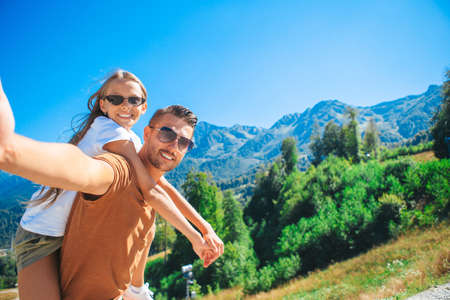 Beautiful happy family in mountains in the background of fog