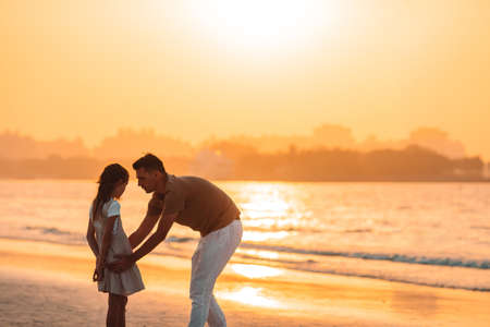 Beautiful father and daughter at the beach enjoying summer vacation.の写真素材