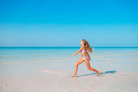 Adorable active little girl at beach during summer vacationの写真素材