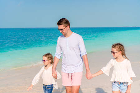 Happy beautiful family on a tropical beach vacationの写真素材