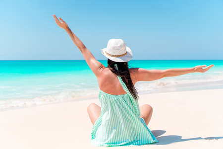 Woman laying on the beach enjoying summer holidays looking at the seaの写真素材