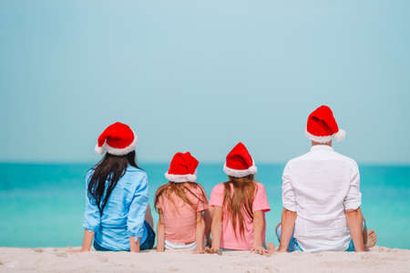 Happy family with two kids in Santa Hat on summer vacationの写真素材