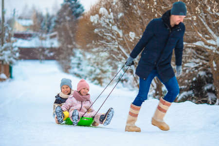 Family of dad and kids vacation on Christmas eve outdoorsの写真素材