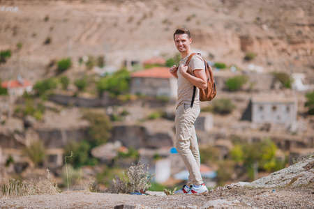 Young man on the edge of canyon in Cappodociaの写真素材