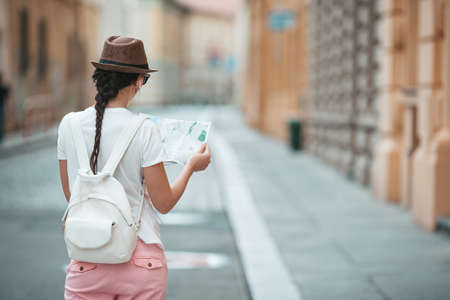 Happy young woman in hat on the street of european city.の写真素材