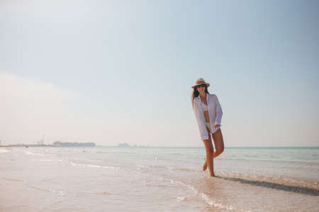 Woman on the beach enjoying summer holidaysの写真素材