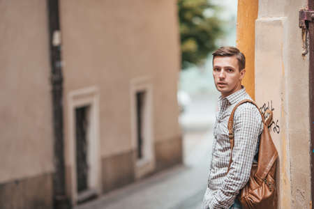 Young caucasian man walking on the street outdoorの写真素材