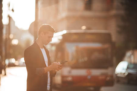 Young caucasian man walking on the street outdoorの写真素材